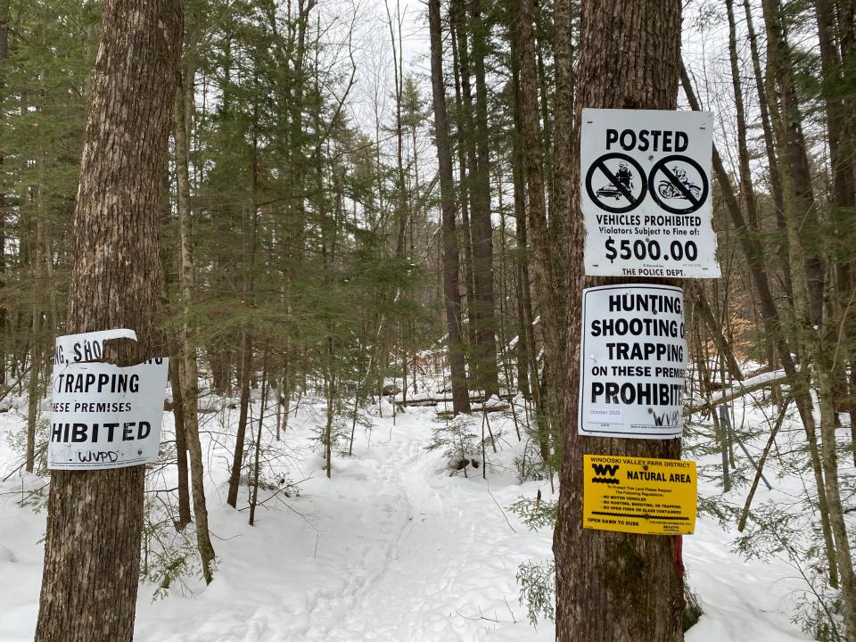 Signs inform users of a Winooski Valley Park District trail that hunting, as well as snowmobiling, shooting and trapping, are prohibited.