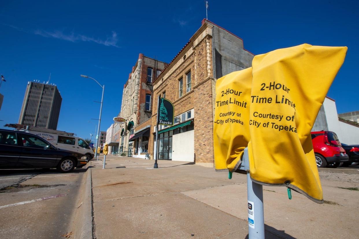 The city of Topeka will resume using bags to cover parking meters in four blocks of S. Kansas Avenue in downtown Topeka as a result of a vote taken Tuesday evening by the city's mayor and council.