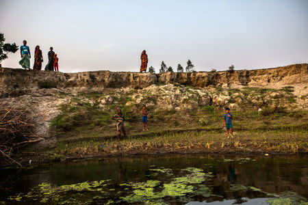 Villagers gather along an eroded river bank in the Jamalpur district of Northern Bangladesh April 19, 2016. Thomson Reuters Foundation/Saiful Huq Omi