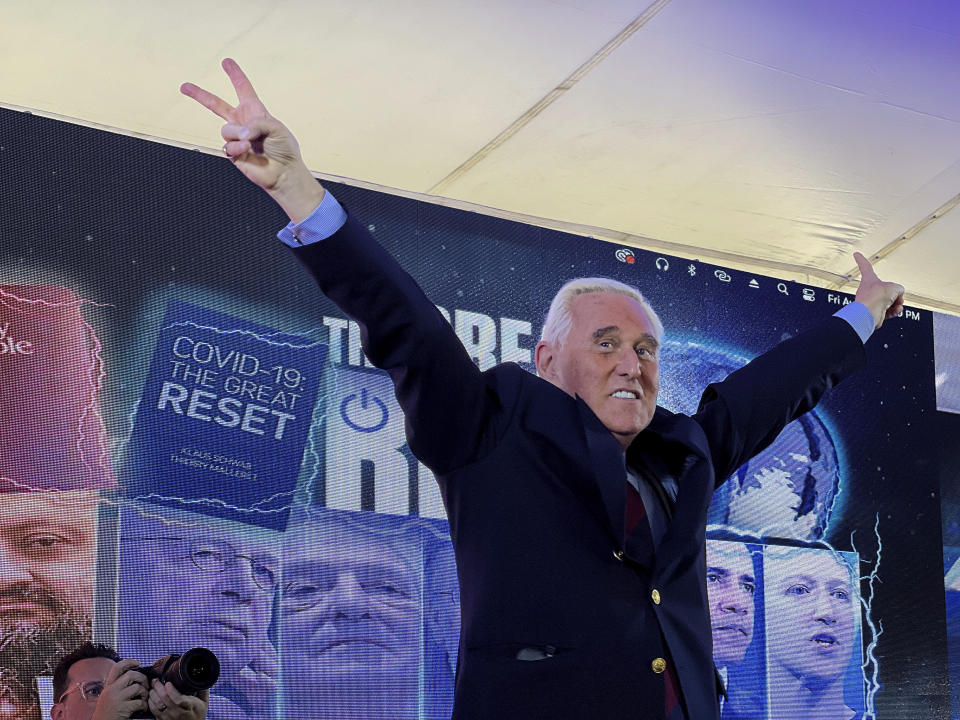 Conservative political consultant Roger Stone gestures victory to the cheering crowd during the ReAwaken America Tour at Cornerstone Church, in Batavia, N.Y., Friday, Aug. 12, 2022. (AP Photo/Carolyn Kaster)