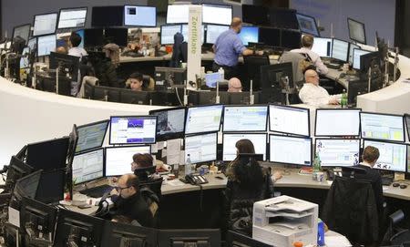 Traders work at their screens at the stock exchange in Frankfurt January 23, 2015. European shares rose in early trade on Friday, gaining ground for the seventh consecutive session, as investors cheered the European Central Bank's decision to buy government bonds. REUTERS/Pawel Kopczynski