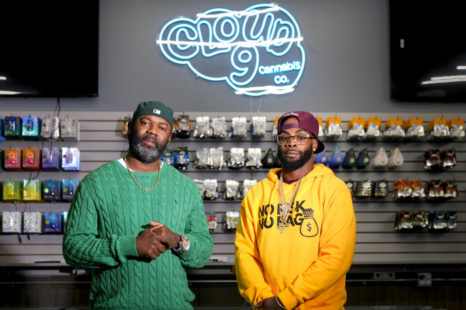 Cloud 9 Cannabis co-owner Dennis Turner, left, poses for a portrait with CEO and co-owner Sam Ward Jr., at their shop, Thursday, Feb. 1, 2024, in Arlington, Wash. Cloud 9 is one of the first dispensaries to open under the Washington Liquor and Cannabis Board's social equity program, established in efforts to remedy some of the disproportionate effects marijuana prohibition had on communities of color. (AP Photo/Lindsey Wasson)