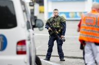 An armed police officer stands guard at the Turku Market Square in the Finnish city of Turku where several people were stabbed on August 18, 2017