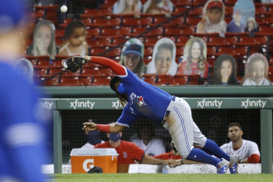 Toronto Blue Jays' Vladimir Guerrero Jr. can not make the play on the pop foul by Boston Red Sox's Xander Bogaerts during the seventh inning of a baseball game, Friday, Aug. 7, 2020, in Boston. (AP Photo/Michael Dwyer)