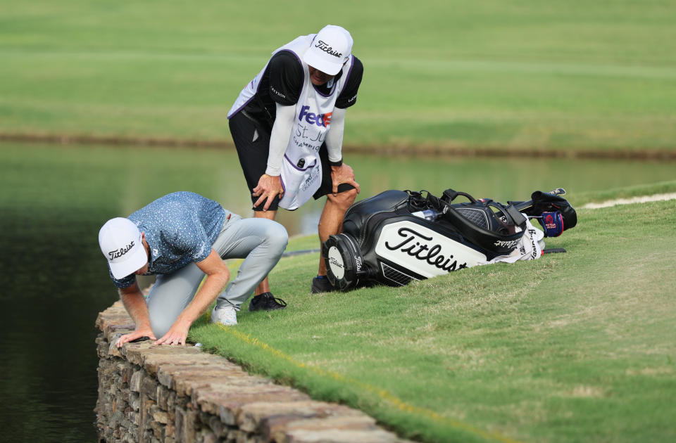 MEMPHIS, TENNESSEE - AUGUST 14: Will Zalatoris of the United States talks with his caddie on the third playoff hole on the 11th green after his ball went in the water during the final round of the FedEx St. Jude Championship at TPC Southwind on August 14, 2022 in Memphis, Tennessee. (Photo by Andy Lyons/Getty Images)