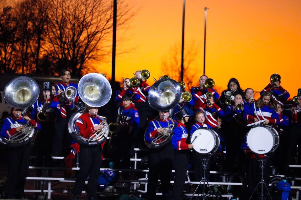 Highland's marching band plays at sunset during Friday night's Division V, Region 18 playoff game at home against Tinora.