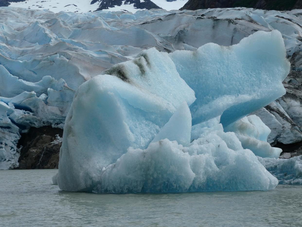 An iceberg floats in front of the Mendenhall Glacier on June 8, 2023, in Juneau, Alaska. Mendenhall Lake separates the glacier from the visitor center area, where buses drop off tourists.