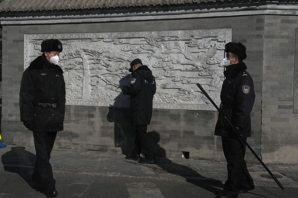 Chinese security personnel guard an area leading to the Great Hall of the People where a memorial for the late former Chinese President Jiang Zemin is held in Beijing, Tuesday, Dec. 6, 2022. A formal memorial service for the late president is held Tuesday at the Great Hall of the People, the seat of the ceremonial legislature in the center of Beijing. (AP Photo/Ng Han Guan)