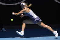 Germany's Angelique Kerber makes a backhand return to Italy's Camila Giorgi during their third round singles match at the Australian Open tennis championship in Melbourne, Australia, Saturday, Jan. 25, 2020. (AP Photo/Andy Brownbill)