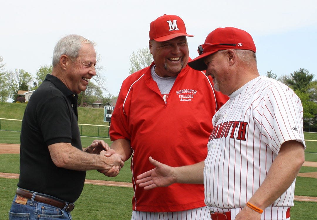 Terry Glasgow (left) congratulates Roger Sander (center) during a retirement ceremony for Sander at Glasgow Field during the 2015 season. The two men, who coached together in both baseball and basketball for many years, combined to post 713 of Monmouth’s first 1,194 baseball victories. Also pictured is current baseball assistant coach Ron Nelson.