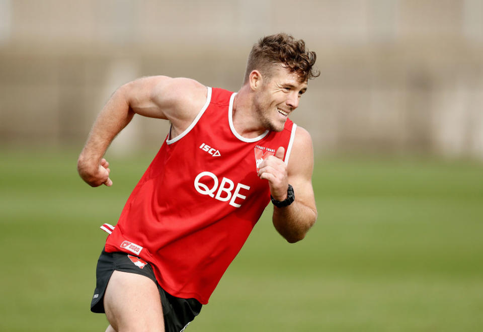 Sydney Swans AFL player training for a game. He is wearing a red guernsey.