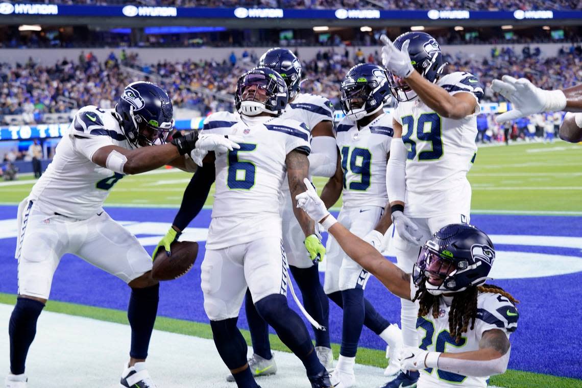 Seattle Seahawks free safety Quandre Diggs (6) celebrates his intercepted pass with teammates during the first half of an NFL football game against the Los Angeles Rams Tuesday, Dec. 21, 2021, in Inglewood, Calif. (AP Photo/Ashley Landis)