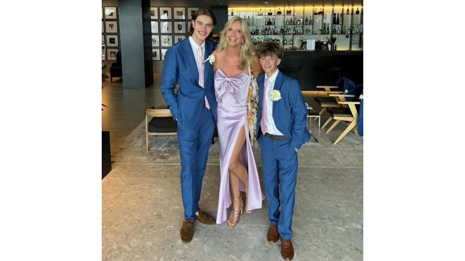 mother posing with two sons at family wedding