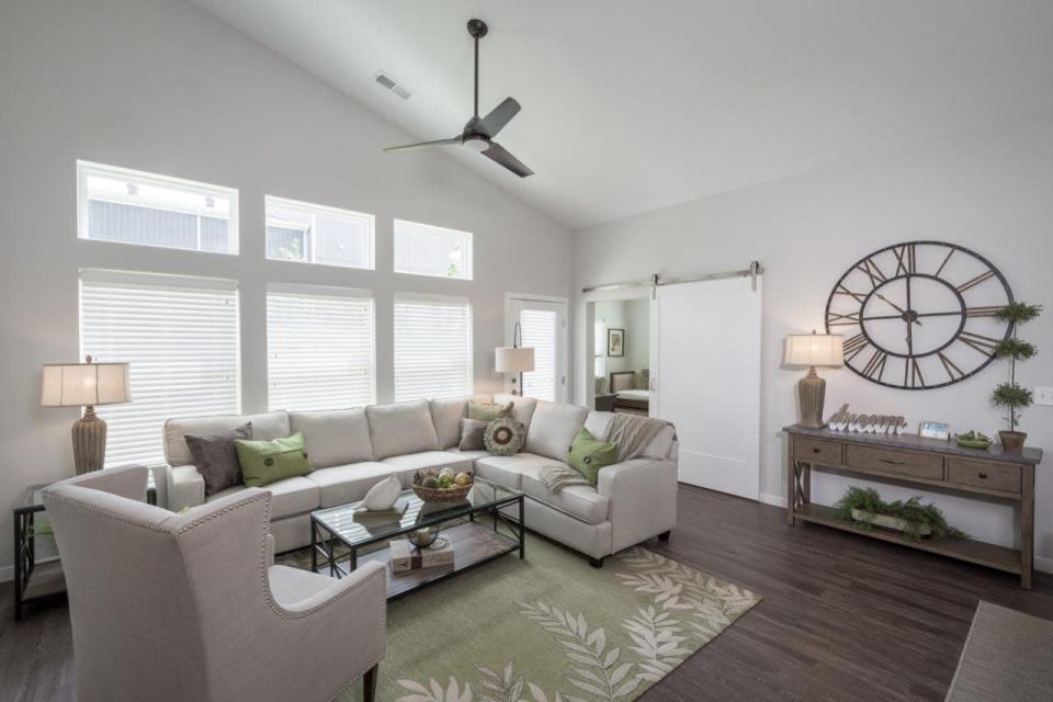 This interior view shows the den/living room of a two-bedroom Treplus Communities unit.