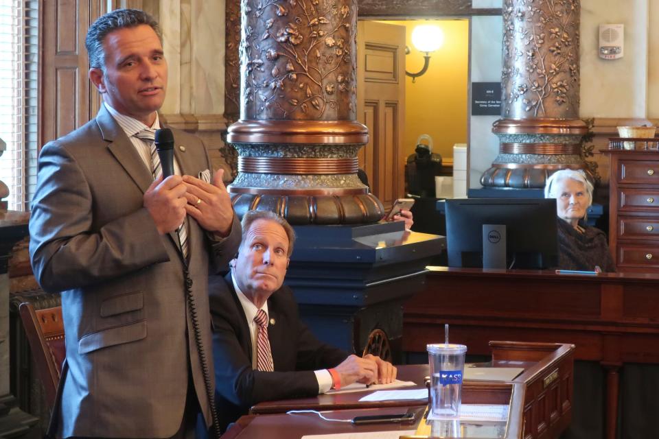 Sen. Ty Masterson, R-Andover, explains his vote in favor of a bipartisan coronavirus bill as Sen. Rick Billinger, R-Goodland, listens Thursday at the Statehouse in Topeka, Kan. Legislators passed a bill that gives their leaders oversight of the state’s response to the pandemic.