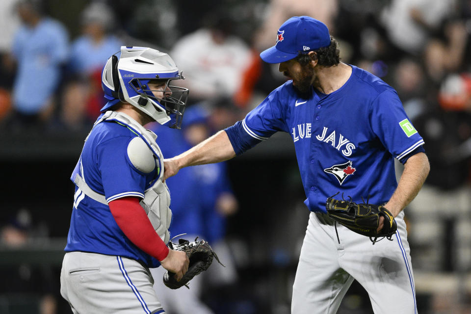 Toronto Blue Jays relief pitcher Jordan Romano, right, and catcher Alejandro Kirk, celebrate after a baseball game against the Baltimore Orioles, Monday, May 13, 2024, in Baltimore. (AP Photo/Nick Wass)