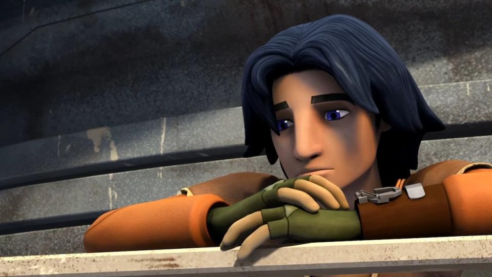 Long-haired Ezra Bridger looks glum with his head on his folded arms on Star Wars Rebels
