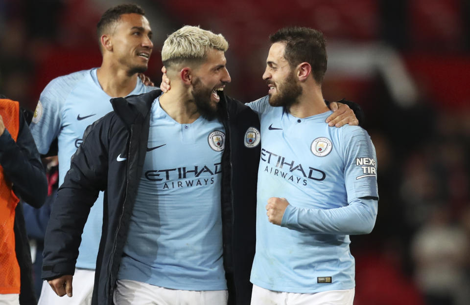 Manchester City's Sergio Aguero, center, and Manchester City's Bernardo Silva, right, celebrate at the end of the English Premier League soccer match between Manchester United and Manchester City at Old Trafford Stadium in Manchester, England, Wednesday April 24, 2019. Manchester City won 2-0. (AP Photo/Jon Super)