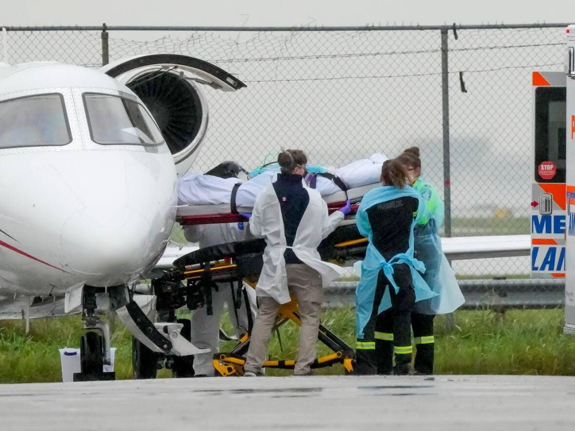 A Saskatchewan COVID-19 patient arrives in Toronto on Oct. 25. The fourth wave of COVID-19 in Saskatchewan has overburdened hospitals and forced the province to move some patients to Ontario.  (Reuters - image credit)