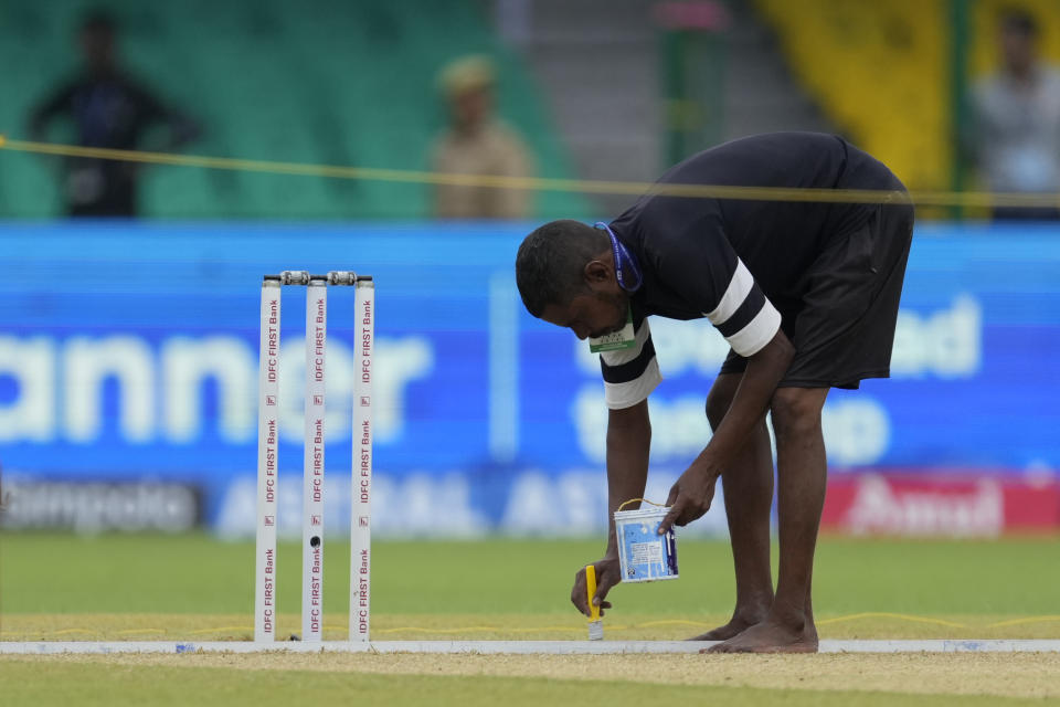 A groundsman prepares the pitch on the third day of the second cricket test match between Bangladesh and India in Kanpur, India, Sunday, Sept. 29, 2024. (AP Photo/Ajit Solanki)