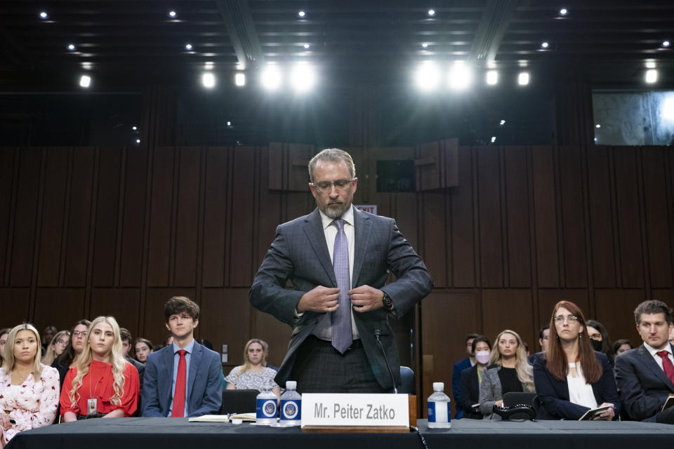 CORRECTS SPELLING FROM PETER TO PEITER - Twitter whistleblower Peiter Zatko buttons his jacket as he rises to be sworn in to testify to a Senate Judiciary hearing examining data security at risk, Tuesday, Sept. 13, 2022, in Washington. (AP Photo/Jacquelyn Martin)