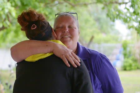 HERplace recovery coach Jamie Riggs embraces a member of the recovery group during a break between sessions at the Barnett Community Center in Huntington, West Virginia May 4, 2017. REUTERS/Lexi Browning