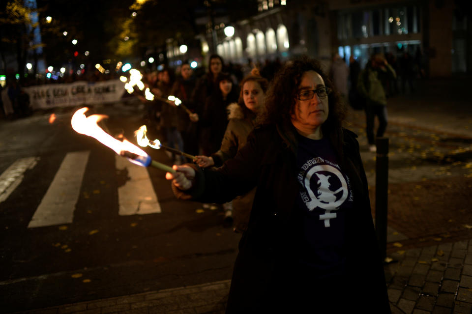 <p>Protesters carry torches and walk behind a banner reading “Your truth is Ours. Our Word Counts” during a demonstration on the World Day for the Elimination of Violence against Women in Bilbao, northern Spain, Nov. 25, 2017. (Photo: Vincent West/Reuters) </p>