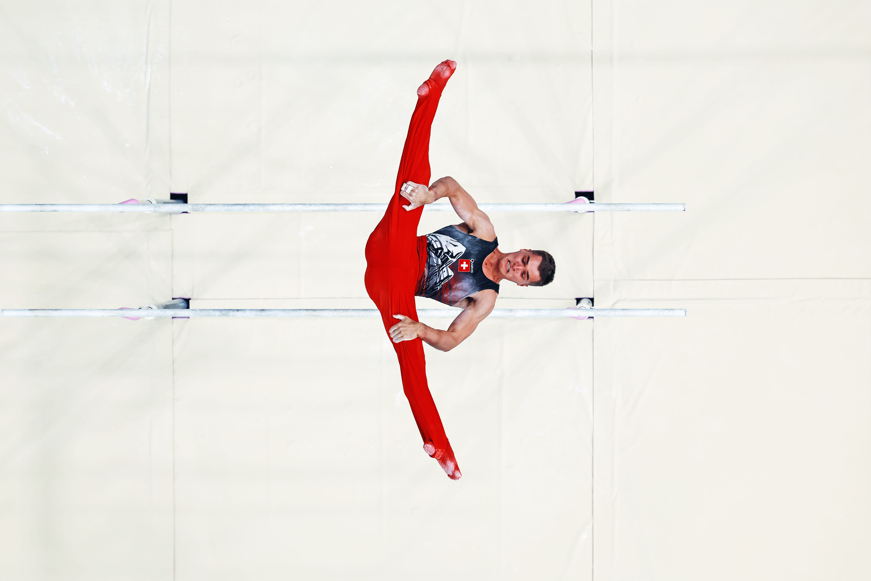 (EDITORS NOTE: Image was captured using a robotic camera positioned above the field of play) Florian Langenegger of Team Switzerland competes on the parallel bars during the Artistic Gymnastics Men's All-Around Final on day five of the Olympic Games Paris 2024 at Bercy Arena on July 31, 2024 in Paris, France. (Photo by Dan Mullan/Getty Images)
