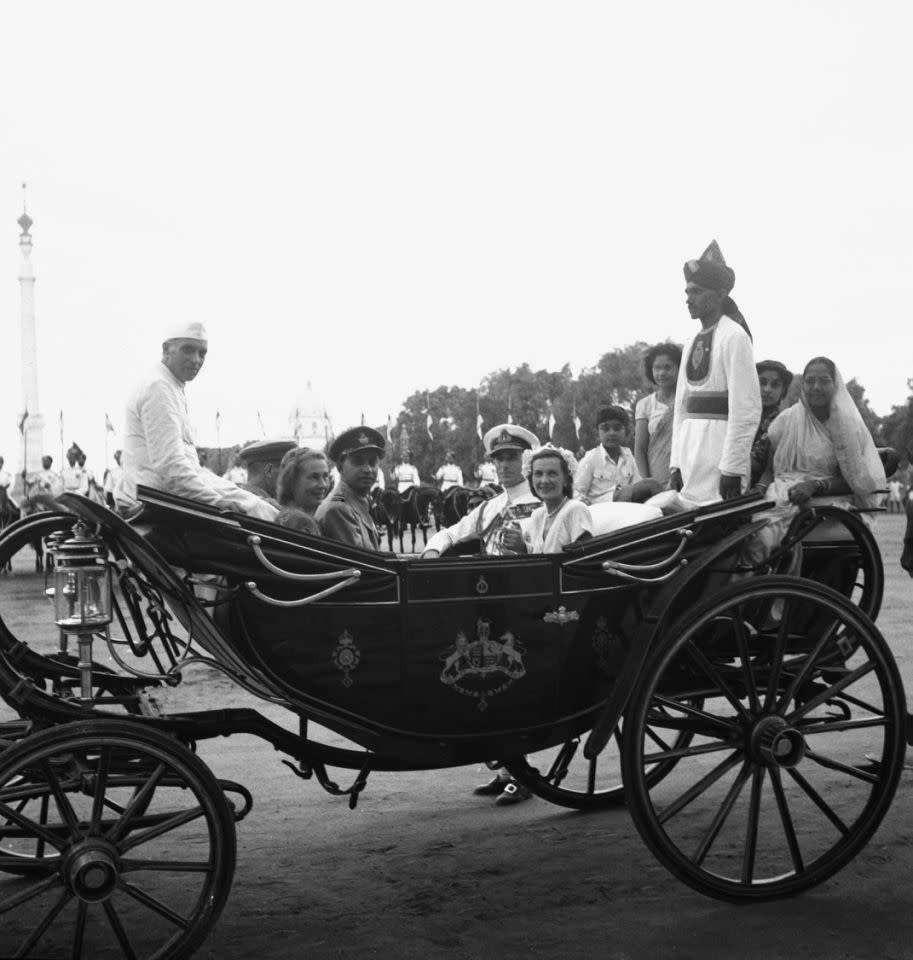 MOUNTBATTEN 1947: Lord and Lady Mountbatten, centre right, ride in a coach with Prime Minister Jawaharlal Nehru, seated on canopy at extreme left, at India’s Independence Day celebrations in New Delhi, Aug. 15, 1947. At right are three women and a small boy saved by the Mountbattens from the crowd of a quarter of a million who broke up the Independence Day military parade. (AP Photo)