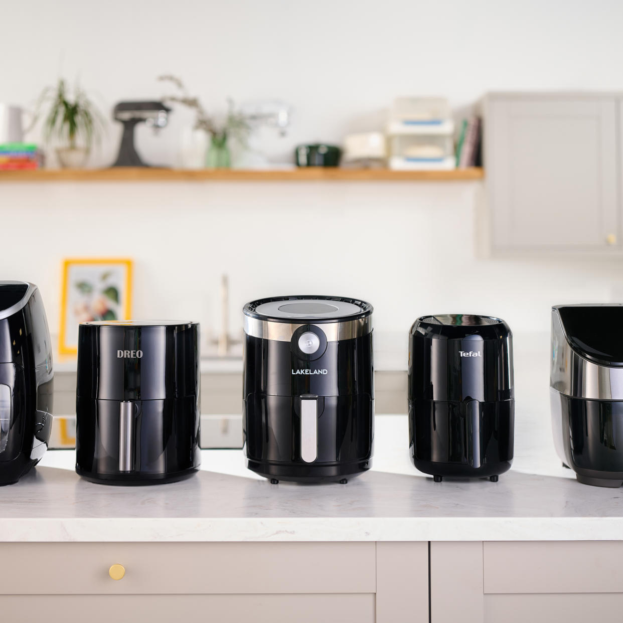  Selection of air fryers on countertop. 