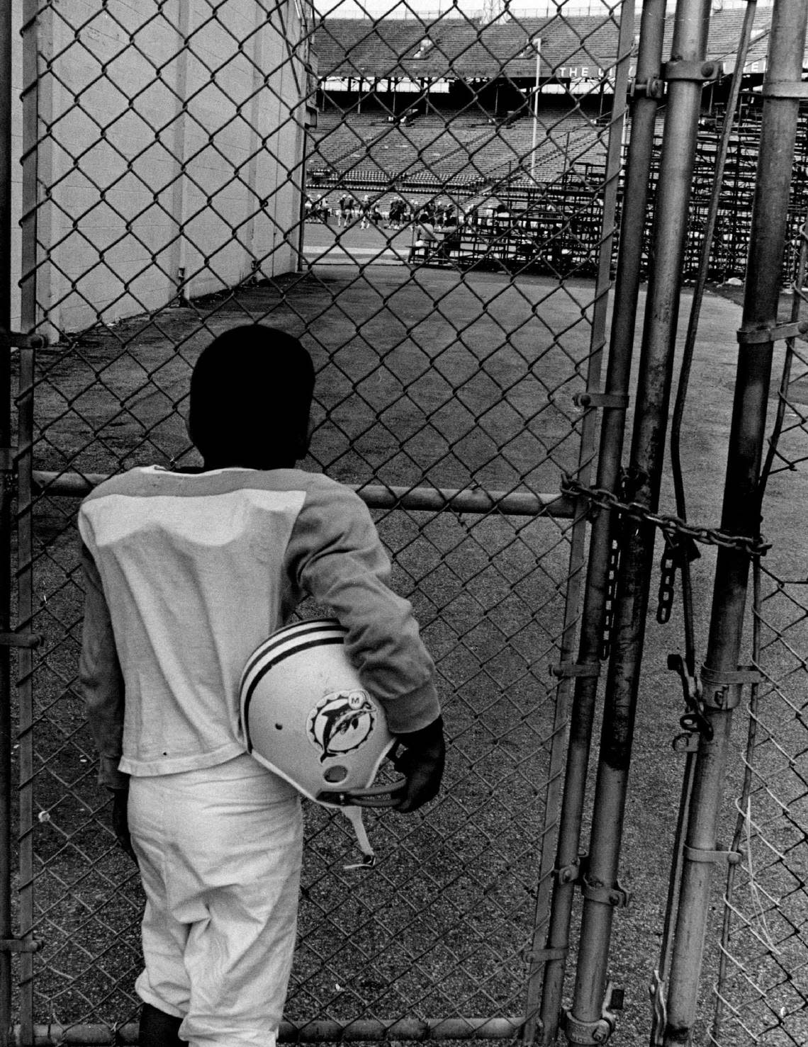 Miami Dolphin had a final fling at the orange bowl, but all gates were kept securely locked and Bernardo Suarez, age 9 had to watch from after thru the east end zone