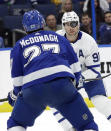 Toronto Maple Leafs center John Tavares (91) eyes a bouncing puck in front of Tampa Bay Lightning defenseman Ryan McDonagh (27) during the first period of an NHL hockey game Thursday, Dec. 13, 2018, in Tampa, Fla. (AP Photo/Chris O'Meara)