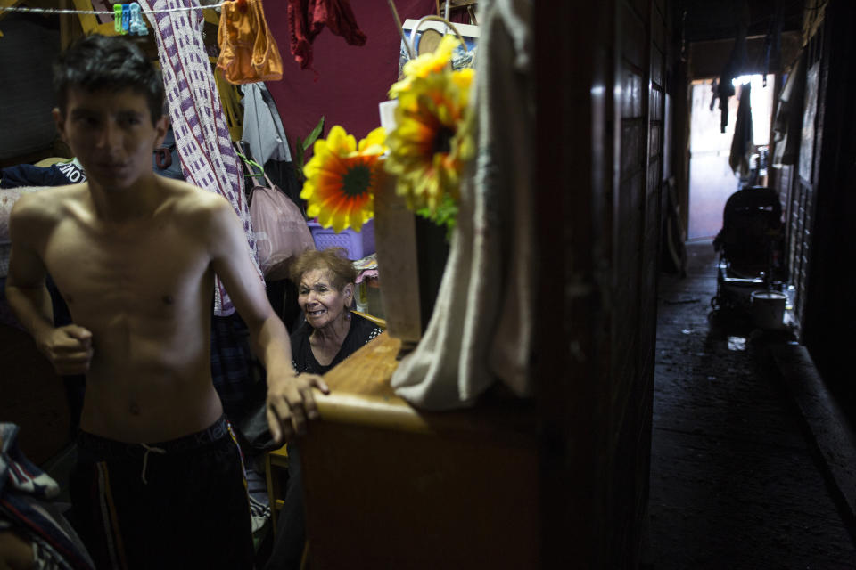 - In this March 19, 2020 photo, Maria Isabel Aguinaga sits inside her room in the rundown building nicknamed “Luriganchito” after the country’s most populous prison, in Lima, Peru. The reference to the prison is not only because the neighbors are mostly ex-convicts, but also because the interior of the house is like a Latin American prison, with narrow passageways, without light and little air. (AP Photo/Rodrigo Abd)