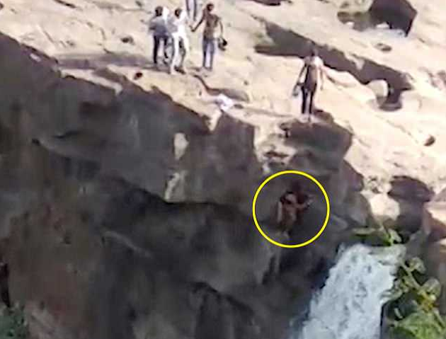 Man dies after falling off 170ft waterfall 'attempting to pose for photo'