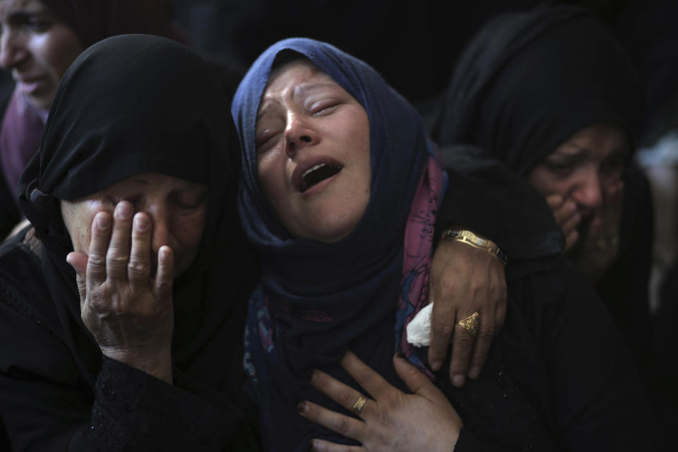 Relatives of Ahmed Abu Lebdeh, 22, who was killed by Israeli troops during Friday's protest at the Gaza Strip's border with Israel, mourn at the family home during his funeral in town of Khan Younis, southern Gaza Strip, Saturday, Oct. 27, 2018. (AP Photo/Khalil Hamra)