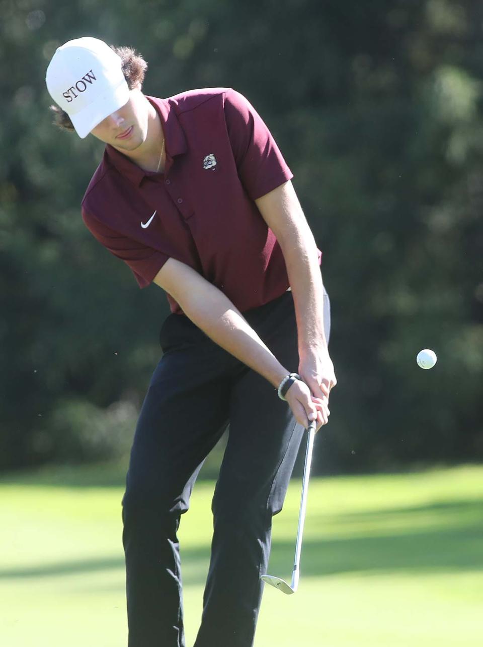 Ben Skripac of Stow chips onto the green during the Division I Boys District Golf Tournament at Pine Hills Golf Course in Hinckley on Monday. 