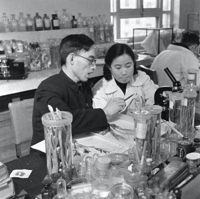 man and woman working at lab bench