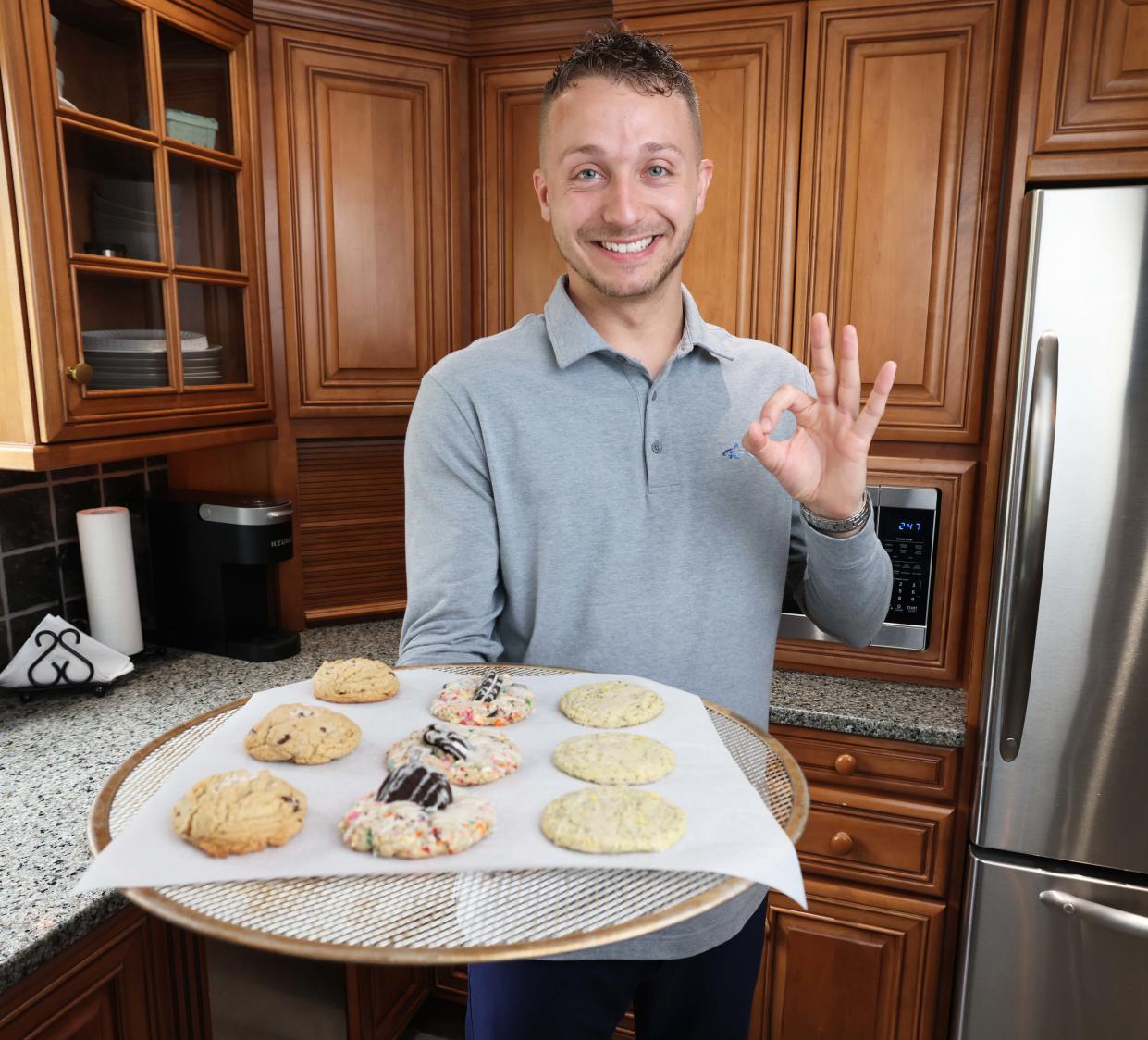 Daniel Gavigan of Middleboro, owner of Danny's Dozens, holds up a tray of his cookie creations on Saturday, May 4, 2024.