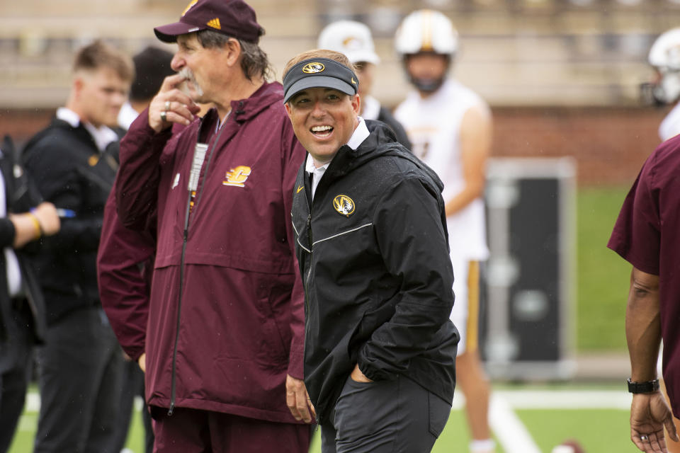 Missouri head coach Eliah Drinkwitz laughs with the Central Michigan coaching staff before the start of an NCAA college football game, Saturday, Sept. 4, 2021, in Columbia, Mo. (AP Photo/L.G. Patterson)
