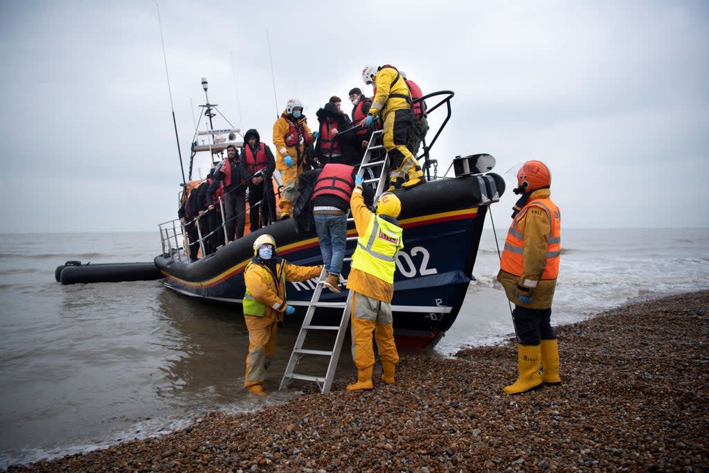 Migrants are helped ashore from an RNLI lifeboat at Dungeness, Kent  (AFP/Getty)