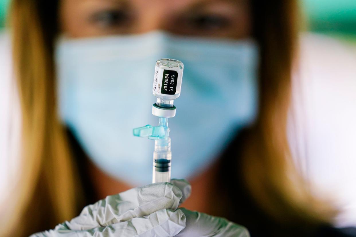 In this Sept. 14, 2021, file photo, a syringe is prepared with the Pfizer COVID-19 vaccine at a clinic at the Reading Area Community College in Reading, Pa.