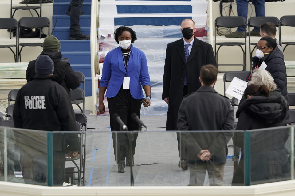 Stand-ins for Vice President-elect Kamala Harris, left, and Doug Emhoff, walk on to the podium during a rehearsal for the 59th Presidential Inauguration at the U.S. Capitol in Washington, Monday, Jan. 18, 2021. (AP Photo/Patrick Semansky, Pool)