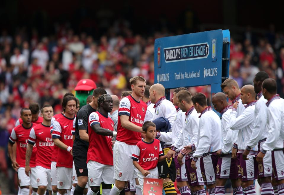 Arsenal's captain Per Mertesacker (centre) shakes hands with the Aston Villa players before the Barclays Premier League match the Emirates Stadium, London.