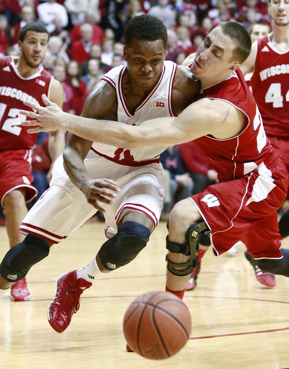 Wisconsin guard Josh Gasser, right, fouls Indiana guard Kevin "Yogi" Ferrell, left, in the second half of an NCAA basketball game in Bloomington, Ind., Tuesday, Jan. 14, 2014. Indiana won 75-72. (AP Photo/R Brent Smith)