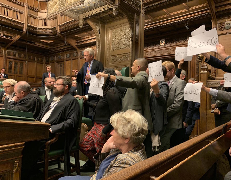 Speaker John Bercow is surrounded by Labour MPs holding paper with "silenced" written on them 