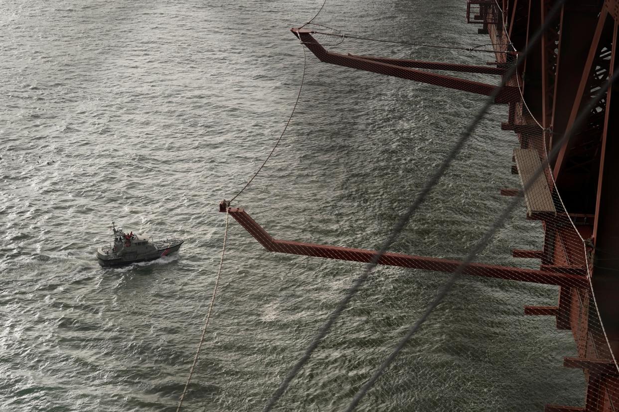 A U.S. Coast Guard boat passes below a suicide deterrent net on the Golden Gate Bridge in San Francisco, Wednesday, Dec. 6, 2023. A suicide prevention barrier at San Francisco's Golden Gate Bridge has been completed as of Jan. 1, 2024 more than a decade after officials approved it.