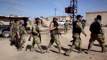 A group of Turkey-backed Syrian fighters prepares for offensive at a village near Turkish border in Yabisa