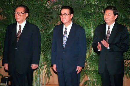 FILE PHOTO: China's Communist Party chief Jiang Zemin stands with fellow members of the party's newly-elected Politburo standing committee Premier Li Peng and Vice Premier Zhu Rongji