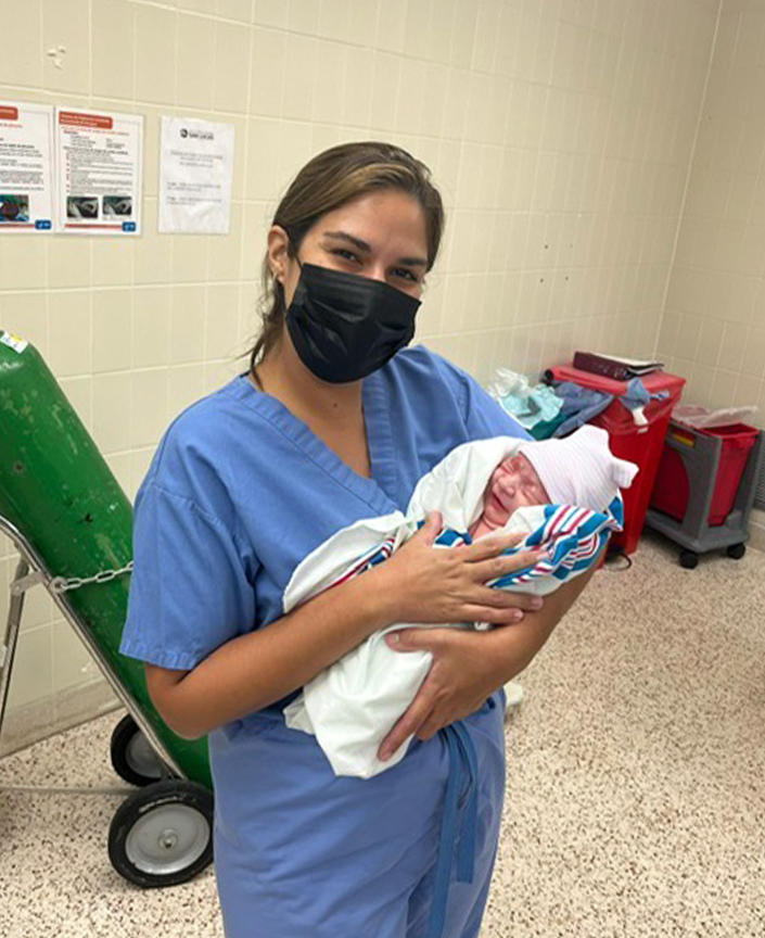 Dr. Zaskia Rodriguez, proudly holding a patient's newborn weeks before Hurricane Fiona hit Puerto Rico.  (Dr. Zaskia Rodriguez)