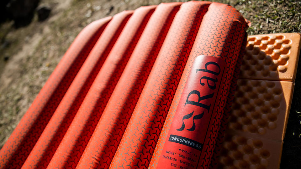 A close-up of an orange Rab Ionosphere 5.5 Sleep Mat.